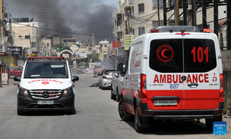 Ambulances are seen during clashes between Palestinians and Israeli forces in the West Bank city of Jenin, on July 3, 2023. At least eight Palestinians were killed and dozens were injured in Jenin on Monday during the Israeli operation launched from midnight throughout the day, said the Palestinian Health Ministry.(Photo: Xinhua)