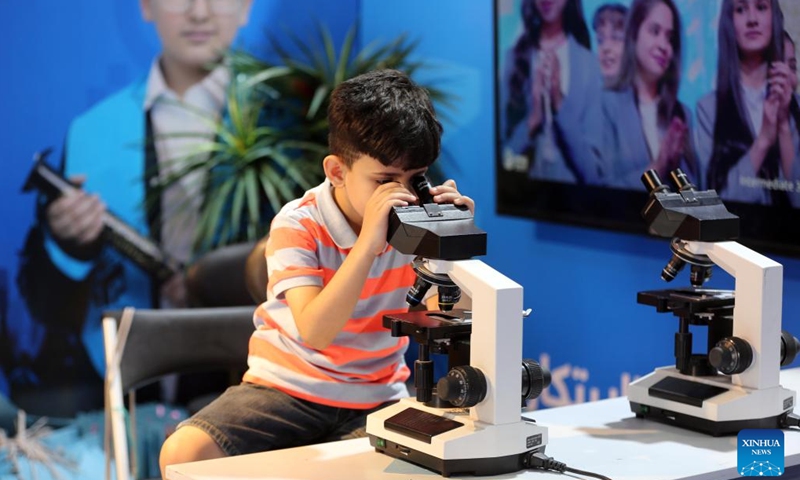 A child looks into a microscope during the second edition of the International Festival for Iraqi Children at the Baghdad International Fair in Baghdad, Iraq, on July 2, 2023. The ten-day festival will last till July 3.(Photo: Xinhua)