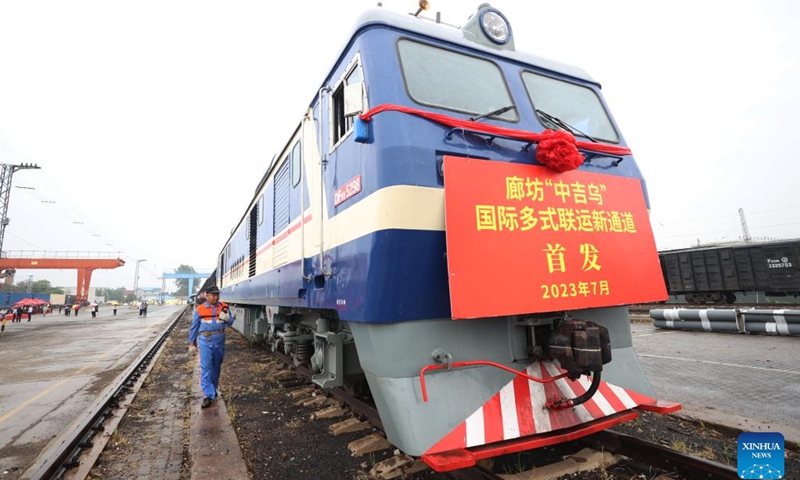 A railway staff member examines the first train of a new international multimodal transport route departing from Langfang City, north China's Hebei Province, July 4, 2023.(Photo: Xinhua)