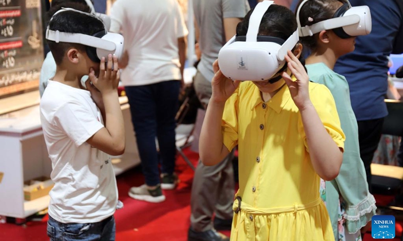 Children try out virtual reality (VR) headsets during the second edition of the International Festival for Iraqi Children at the Baghdad International Fair in Baghdad, Iraq, on July 2, 2023. The ten-day festival will last till July 3.(Photo: Xinhua)
