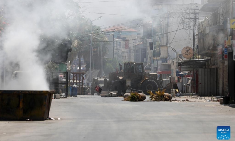 Smoke rises during clashes between Palestinians and Israeli forces in the West Bank city of Jenin, on July 3, 2023. At least eight Palestinians were killed and dozens were injured in Jenin on Monday during the Israeli operation launched from midnight throughout the day, said the Palestinian Health Ministry.(Photo: Xinhua)