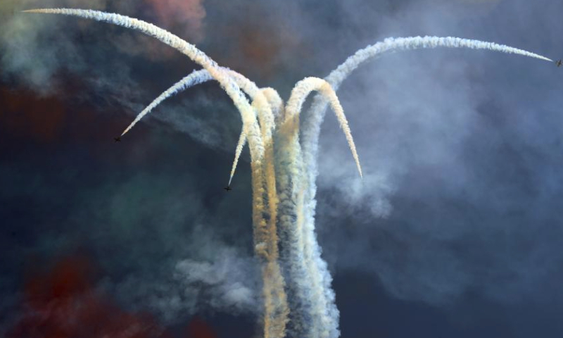 Aircrafts perform aerobatics during the El-Alamein Air Show 2023 in the New Alamein City, Egypt, July 23, 2023. Aircrafts from Egypt and the United Arab Emirates (UAE) on Sunday jointly staged the El-Alamein Air Show 2023 at the Mediterranean coastal city of New Alamein. (Xinhua/Ahmed Gomaa)
