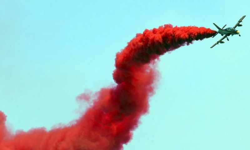 An aircraft performs aerobatics during the El-Alamein Air Show 2023 in the New Alamein City, Egypt, July 23, 2023. Aircrafts from Egypt and the United Arab Emirates (UAE) on Sunday jointly staged the El-Alamein Air Show 2023 at the Mediterranean coastal city of New Alamein. (Xinhua/Ahmed Gomaa)