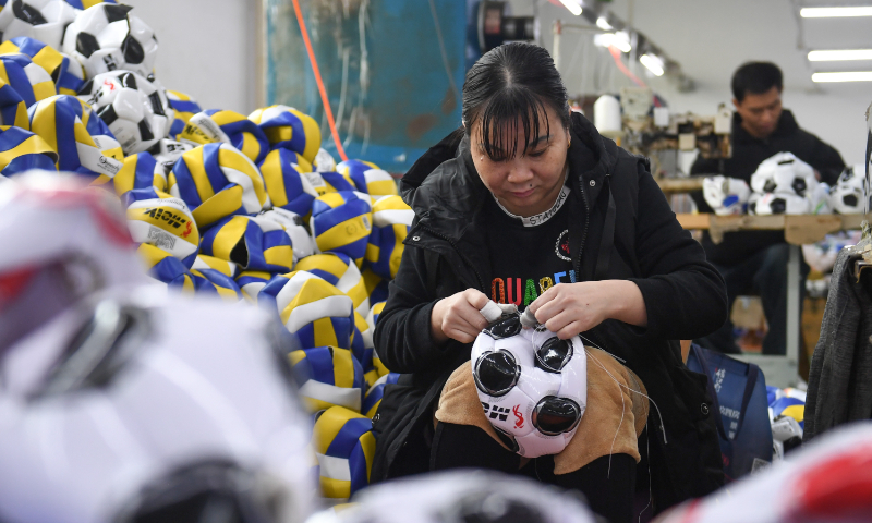 Workers make footballs at a factory in Yiwu, East China’s Zhejiang Province, on December 5, 2022. Photo: VCG