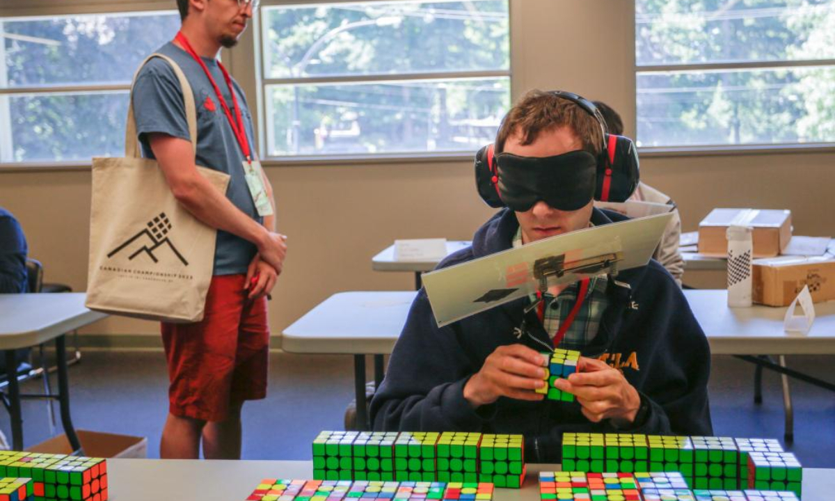 A contestant solves a Rubik's Cube blindfolded during the Canadian Speedcubing Championship 2023 at the Queen's Park Arena in New Westminster, British Columbia, Canada, on July 13, 2023. A total of 320 contestants from 20 countries and regions took part in the championship from July 13 to 16. Photo:Xinhua