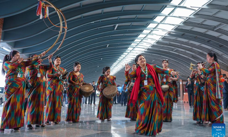 Nepali performers perform outside the airport to welcome the arrival of Chinese trekkers in Kathmandu, Nepal, April 13, 2023. Photo: Xinhua