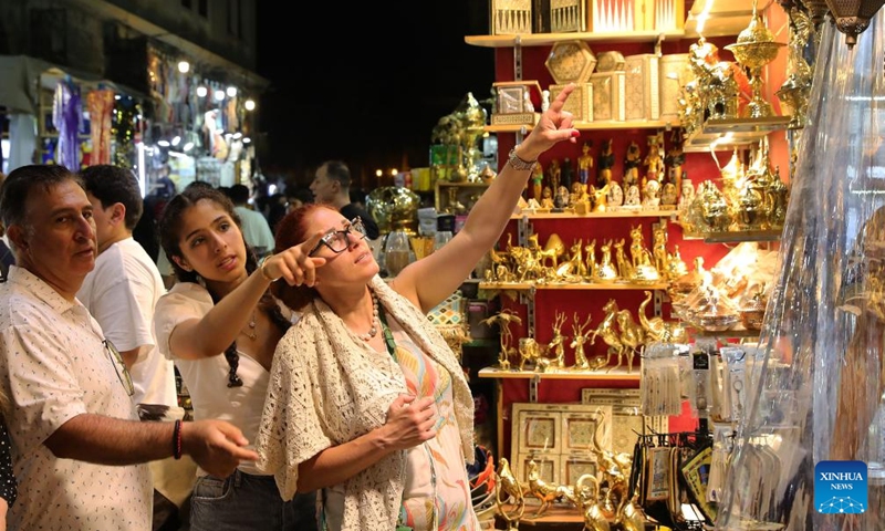 People visit the Khan el-Khalili market at night in Cairo, Egypt, July 8, 2023. Located at the heart of Cairo's old Islamic district, Khan el-Khalili is one of the most famed tourist bazaars in the Egyptian capital. (Xinhua/Wang Dongzhen)