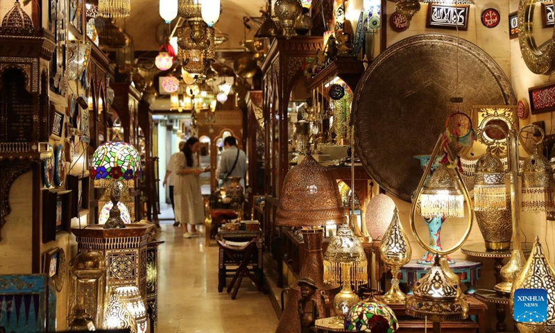 People visit the Khan el-Khalili market at night in Cairo, Egypt, July 8, 2023. Located at the heart of Cairo's old Islamic district, Khan el-Khalili is one of the most famed tourist bazaars in the Egyptian capital. (Xinhua/Wang Dongzhen)