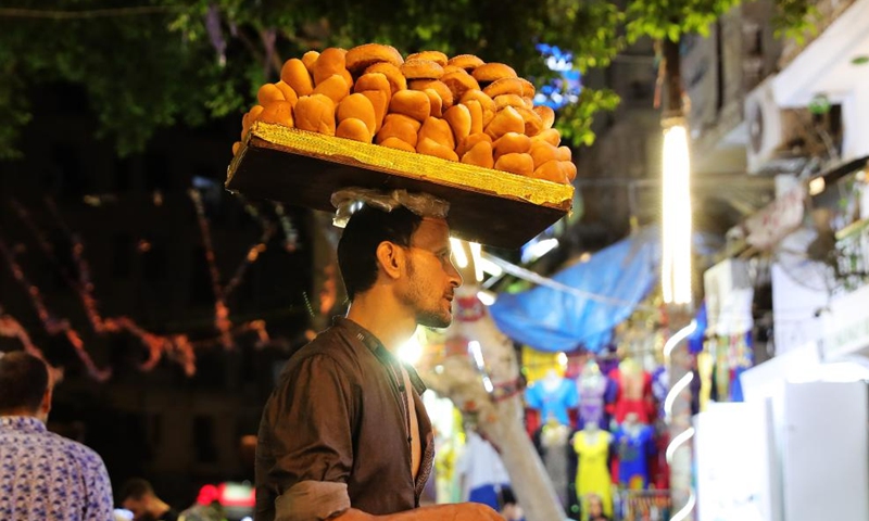 A peddler is seen at the Khan el-Khalili market at night in Cairo, Egypt, July 8, 2023. Located at the heart of Cairo's old Islamic district, Khan el-Khalili is one of the most famed tourist bazaars in the Egyptian capital. (Xinhua/Wang Dongzhen)
