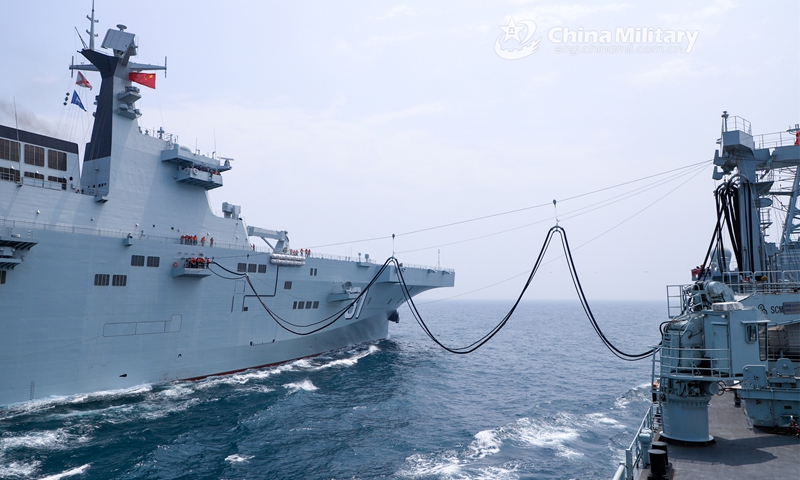 A comprehensive supply ship attached to a navy support flotilla under the PLA Southern Theater Command provides liquid supply to amphibious assault ship Hainan via alongside replenishment-at-sea during a comprehensive support exercise on May 19, 2023. (eng.chinamil.com.cn/Photo by Liu Ruiyan)