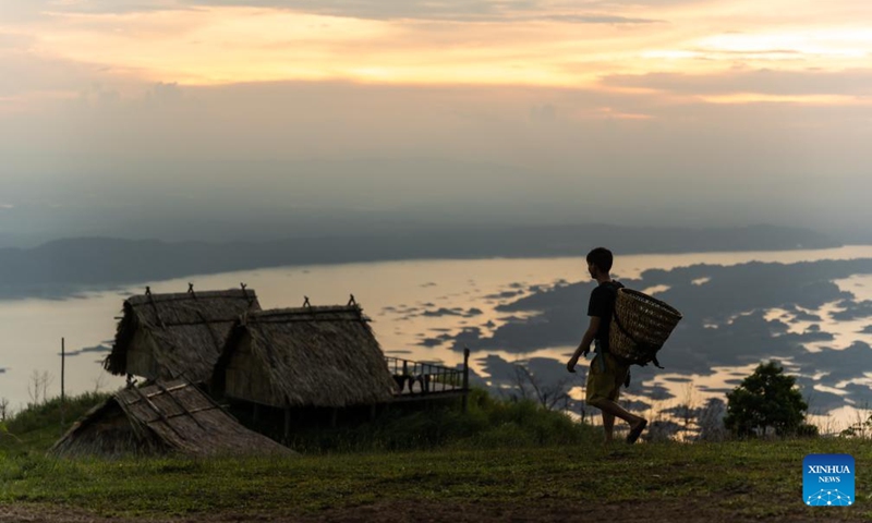 This photo taken on July 8, 2023 shows a camping site at sunset by the Nam Ngum Lake in Vientiane Province, Laos. The Nam Ngum Lake, located at the lower reaches of the Nam Ngum River, a tributary of Mekong River, is known as the thousand-island lake in Laos.(Photo: Xinhua)