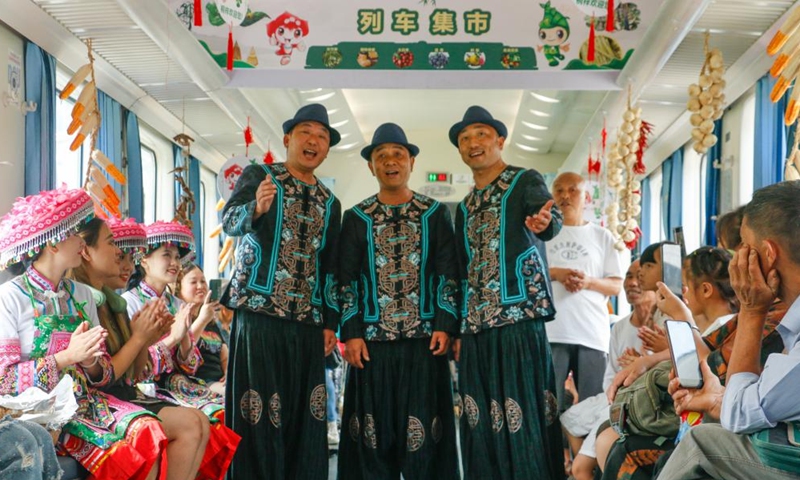 Staff members sing on train No. 5630 from Zunyi, southwest China's Guizhou Province to southwest China's Chongqing Municipality, July 11, 2023. Trains No.5630 and 5629 are slow trains operating between Zunyi of Guizhou Province and Chongqing Municipality in southwest China.(Photo: Xinhua)