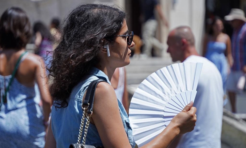 A woman uses a fan to cool off in Rome, Italy, on July 10, 2023. Rome and other cities across Italy were put on red alert on Monday as the country was bracing for an intense heatwave that meteorologists said was likely to break records.(Photo: Xinhua)