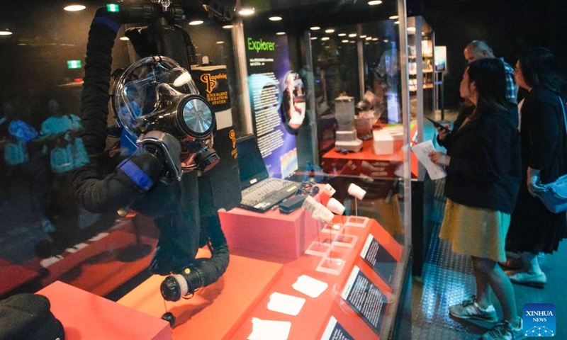 People look at different equipment used for the deep sea exploration during James Cameron-Challenging the Deep exhibition at Science World in Vancouver, British Columbia, Canada, on July 10, 2023. James Cameron-Challenging the Deep is an immersive exhibition that showcases the filmmaker's achievements and innovations in deep-sea exploration and filmmaking.(Photo: Xinhua)