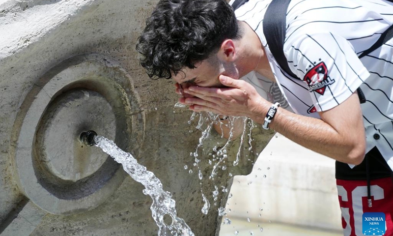 A man refreshes himself with water from the Barcaccia Fountain in the Piazza di Spagna in Rome, Italy, on July 10, 2023. Rome and other cities across Italy were put on red alert on Monday as the country was bracing for an intense heatwave that meteorologists said was likely to break records.(Photo: Xinhua)
