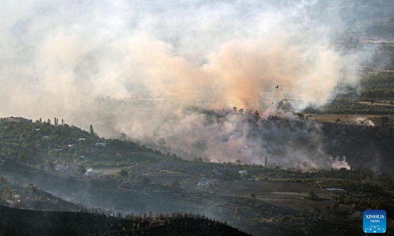Smoke and flames rise from the wildfires as the intervention continues by land and air in Gulnar District of Mersin Province, Türkiye, July 17, 2023. Wildfires broke out in the southern and western provinces of Türkiye over the weekend as summer heat grips a large swathe of the country, local media reported on Monday.(Photo: Xinhua)