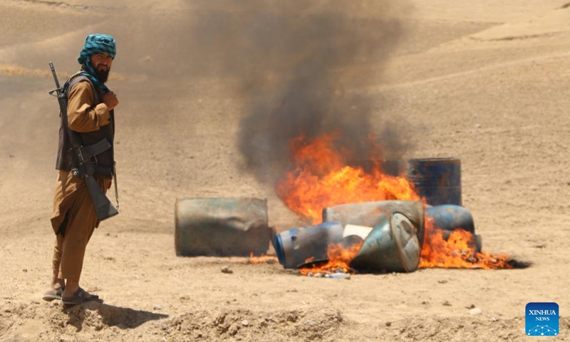 An Afghan security personnel burns down drug processing facilities in Jawzjan province, Afghanistan, July 10, 2023. Police have discovered and destroyed a drug processing lab and arrested its owner in north Afghanistan's Jawzjan province, Mohammad Younus Akhundzada, the provincial director for counter-narcotics police, said Wednesday.(Photo: Xinhua)