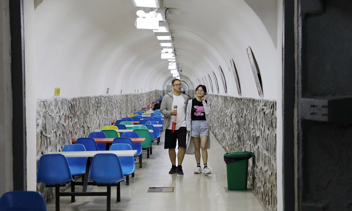 A couple walks in an air raid shelter used as public cooling center in Xi'an, Northwest China's Shaanxi Province on July 13, 2023. Photo: VCG