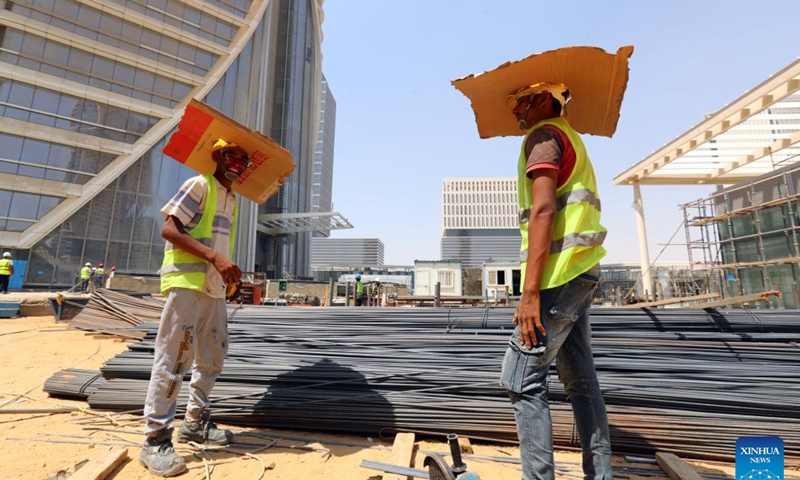 Laborers work at the construction site of the Central Business District (CBD) project in the new administrative capital, east of Cairo, Egypt, July 24, 2023. (Xinhua/Sui Xiankai)