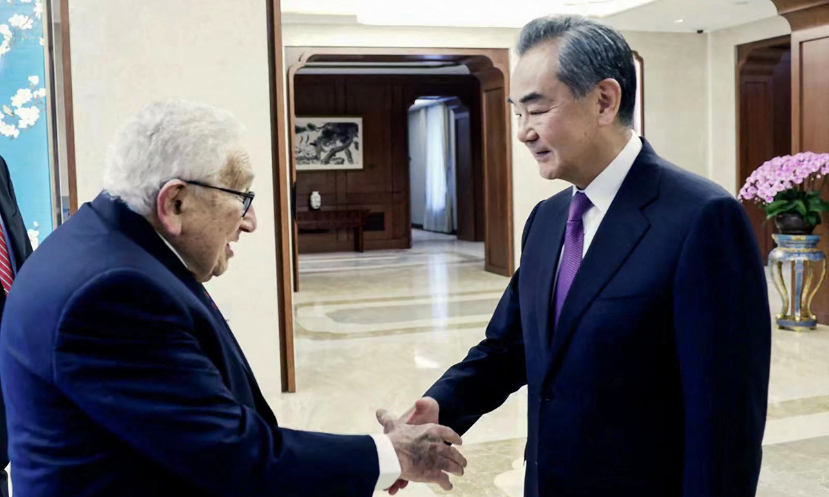 Wang Yi, director of the Office of the Foreign Affairs Commission of the Communist Party of China (CPC) Central Committee, shakes hands with visiting centenarian former US secretary of state Henry Kissinger as they meet in Beijing on July 19, 2023. Photo: AFP