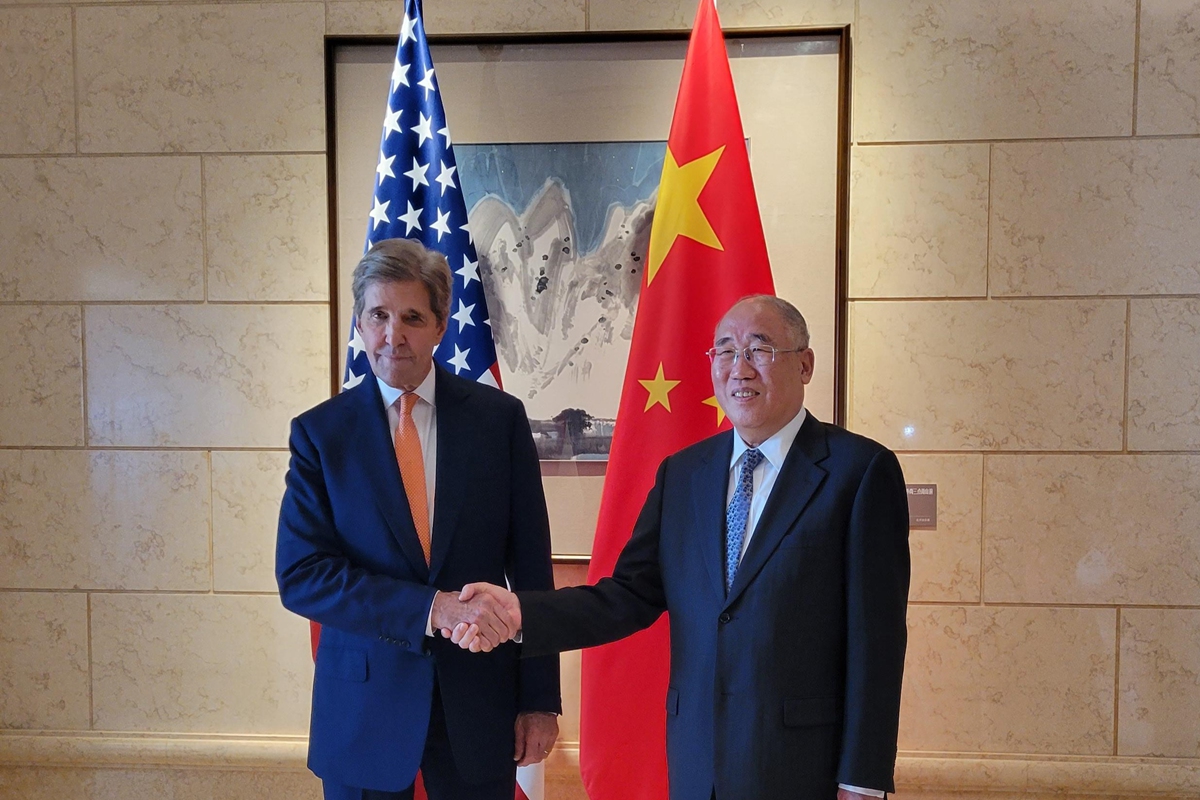 Xie Zhenhua, China's special envoy for climate change, shakes hands with visiting US climate envoy John Kerry ahead of their talks in Beijing on July 17, 2023. Photo: VCG