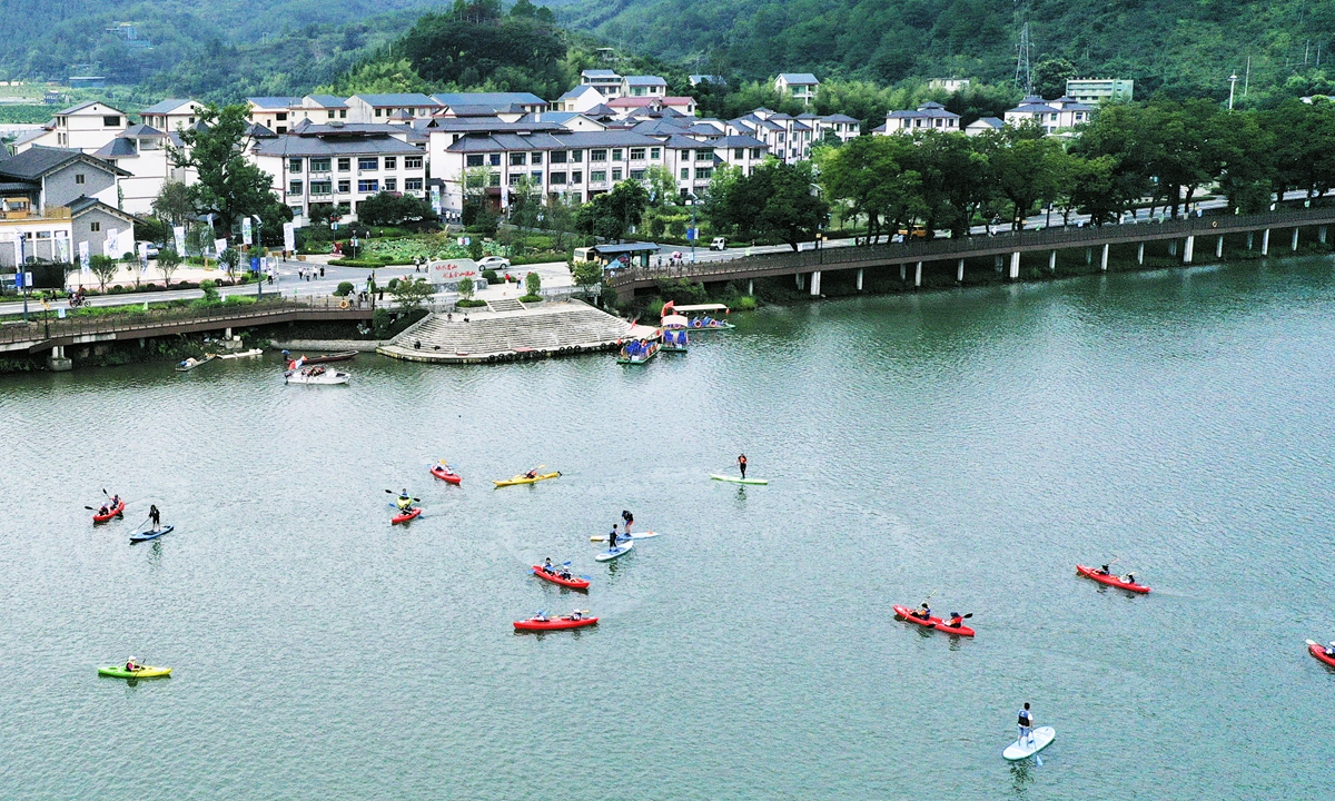 People are kayaking and paddleboarding on Jinxi River in Jiangle county, East China's Fujian Province on August 15, 2023, the country's first National Ecology Day. Jiangle has a forest coverage rate of 81.3 percent and is a key eco-protection site. Photo: cnsphoto 