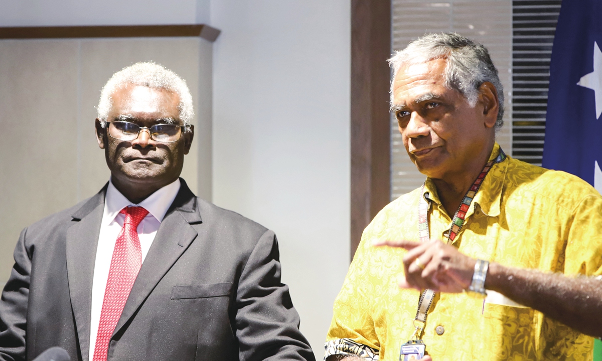 Solomon Islands' Prime Minister Maanasseh Sogavare (left) and Secretary to the Prime Minister Jimmie Rodgers speak at a press conference in Honiara on July 17, 2023. Sogavare said that while in China, he signed nine agreements and memorandums, including a police cooperation plan. He said the plan