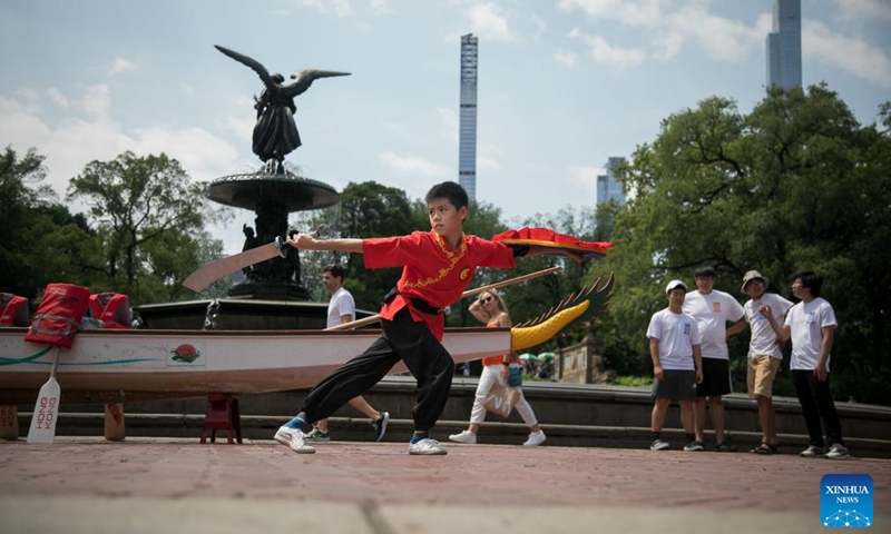 A martial artist performs during a dragon eye dotting ceremony of Hong Kong Dragon Boat Festival in Central Park in New York, the United States, on July 20, 2023. A dragon eye dotting ceremony was held in New York City, the United States, on Thursday as a prelude to the 2023 Hong Kong Dragon Boat Festival, which is scheduled for next month.(Photo: Xinhua)