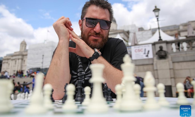 A man plays chess during the ChessFest at the Trafalgar Square in London, Britain, July 16, 2023. ChessFest, an annual open-air chess festival in Britain, took place in London on Sunday.(Photo: Xinhua)
