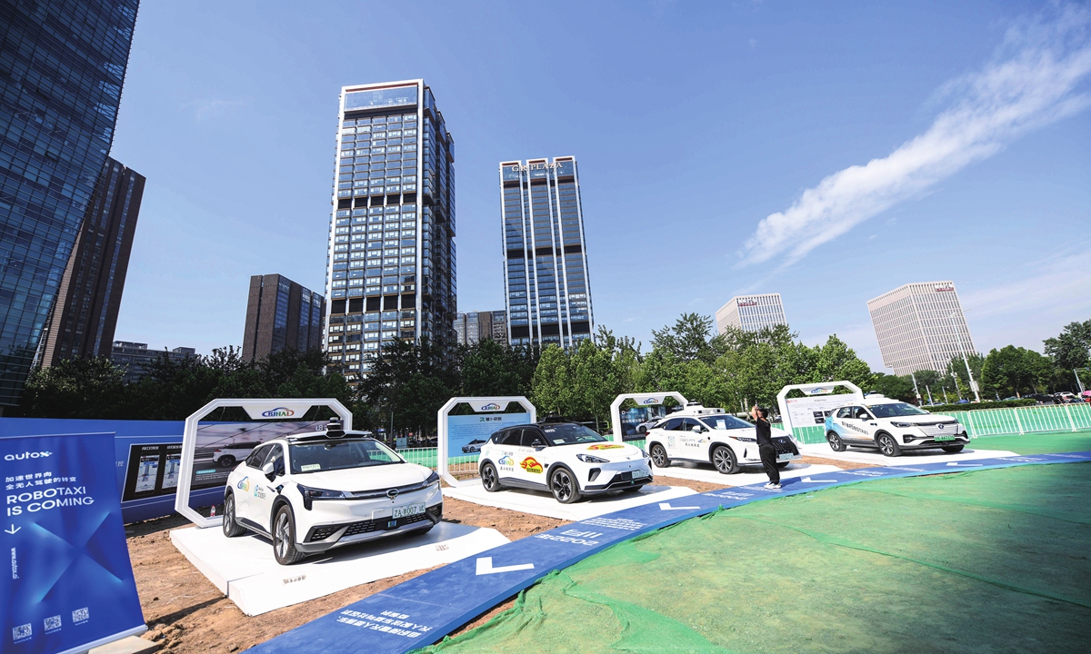 A visitor learns about new technologies and products at an autonomous driving fair in Beijing on July 7, 2023. Photo: VCG