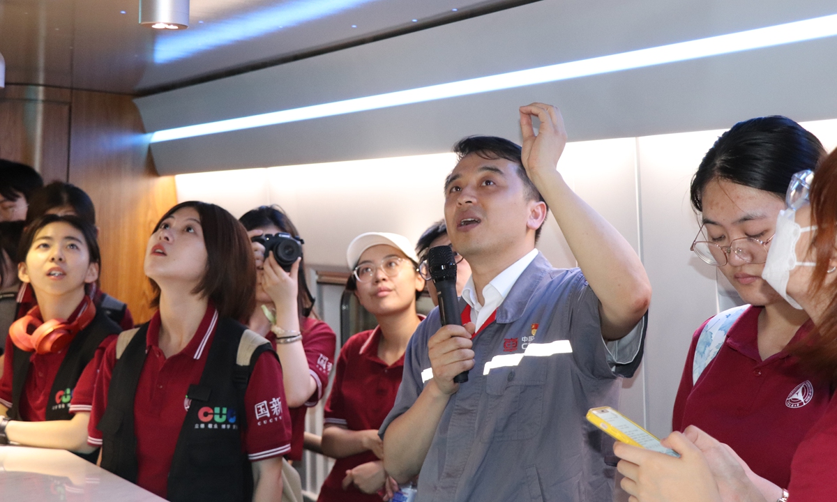 Liu introduces the EMU roof lighting design to visitors on July 22, 2023. Photo: Chen Yang