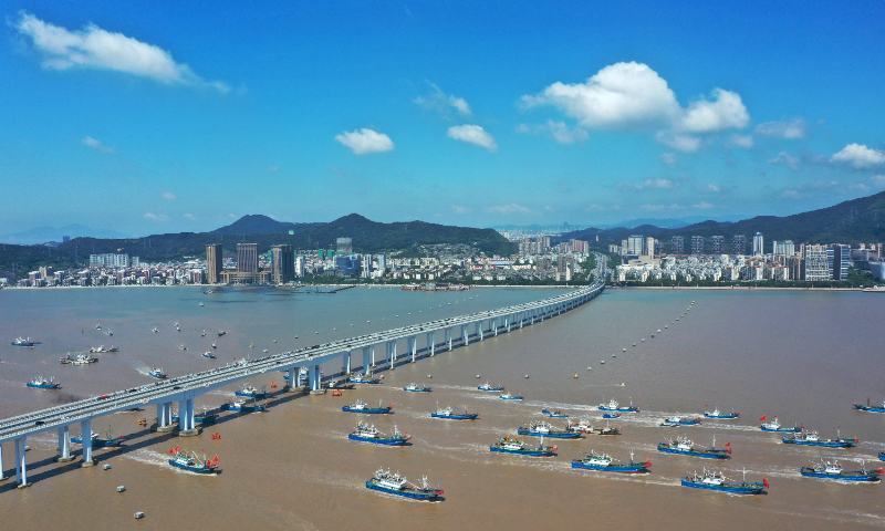 Fishing vessels cross under a bridge in Zhoushan, East China's Zhejiang Province and enter the East China Sea fishing ground to start operations on August 6, 2023. Due to the impact of Typhoon Khanun, the summer fishing ban, which was scheduled to end at noon on August 1, was postponed until 10 am on August 6. Photo: cnsphoto