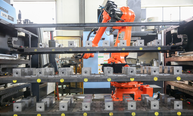A robotic arm processes hydraulic parts in an intelligent workshop of Huadong Hydraulic Technology Co in Nantong, East China's Jiangsu Province, on August 7, 2023. In recent years, the company has improved its production efficiency and extended its industrial chain through scientific and technological innovation, and achieved growth in both production and marketing. Photo: VCG