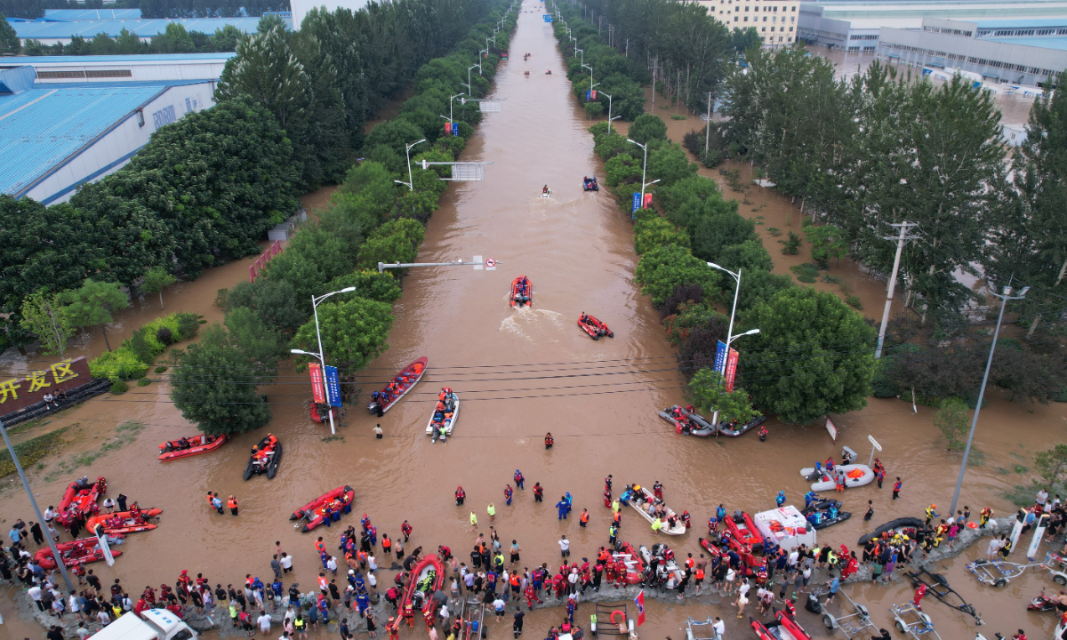 Rescue teams evacuate residents by rubber boats in Zhuozhou, North China's Hebei Province on August 2, 2023. The region has been hit by floods due to heavy rainfall. Photo: IC