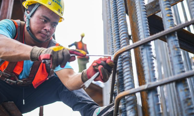 Workers work at the construction site of the Huajiang grand canyon bridge in southwest China's Guizhou Province, Aug. 3, 2023. With a vertical height of 625 meters from the bridge deck down to the water's surface, the Huajiang grand canyon bridge is expected to become the highest in the world after completion in 2025. It will cut the travel time across the canyon from about an hour to a mere minute. (Xinhua/Tao Liang)