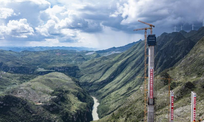 This aerial photo taken on Aug. 2, 2023 shows the construction site of the Huajiang grand canyon bridge in southwest China's Guizhou Province. With a vertical height of 625 meters from the bridge deck down to the water's surface, the Huajiang grand canyon bridge is expected to become the highest in the world after completion in 2025. It will cut the travel time across the canyon from about an hour to a mere minute. (Xinhua/Tao Liang)