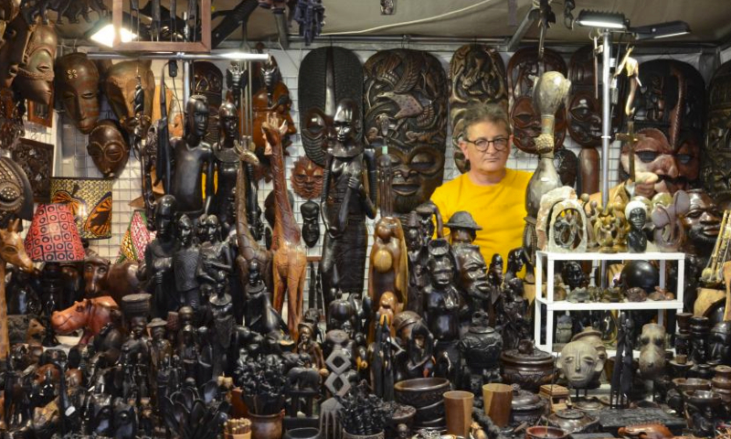 A man sells African wood crafts at St. Dominic's Fair in Gdansk, Poland, July 30, 2023. The St. Dominic's Fair is held in Poland's port city of Gdansk from July 22 to Aug. 13 this year. (Xinhua/Chen Chen)