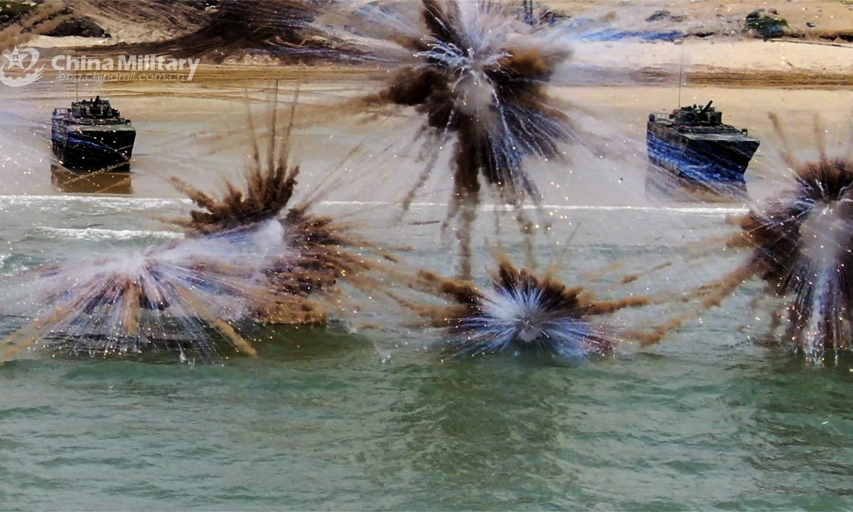 Amphibious assault vehicles attached to a brigade under the PLA 73rd Group Army launch smoke shells before entering the water during a live-fire training exercise held recently. Photo:China Military