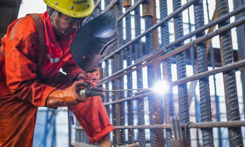 A worker works at the construction site of the Huajiang grand canyon bridge in southwest China's Guizhou Province, Aug. 3, 2023. With a vertical height of 625 meters from the bridge deck down to the water's surface, the Huajiang grand canyon bridge is expected to become the highest in the world after completion in 2025. It will cut the travel time across the canyon from about an hour to a mere minute. (Xinhua/Tao Liang)