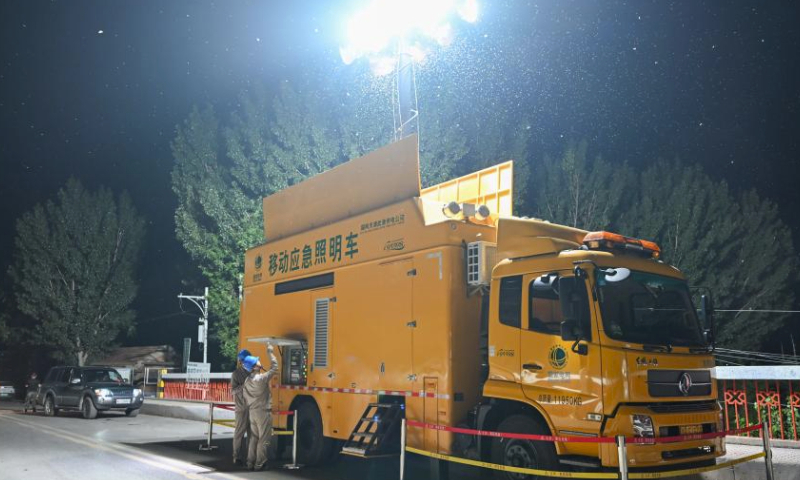 Workers of the State Grid Tianjin Electric Power Company ensure lighting on a bridge in Taitou Town of Jinghai District, north China's Tianjin Municipality, Aug. 4, 2023. All residents of 18 villages under the administration of the Taitou Town have been evacuated to safety before noon of Aug. 3. All the town's flood rescue teams including members of the armed police force in Tianjin, the Blue Sky Rescue Team, local officials and rescue workers are standing by to brace for flooding from upstream river which is expected to arrive here on Aug. 4. (Xinhua/Sun Fanyue)