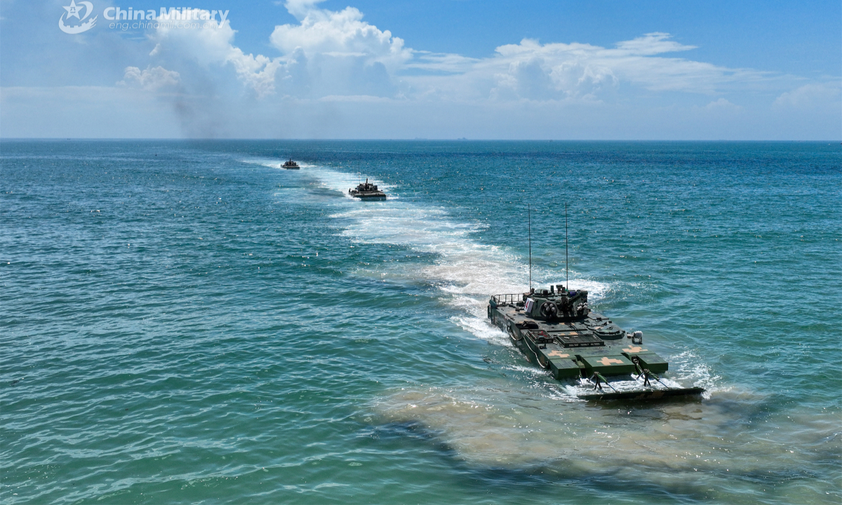 Amphibious assault vehicles attached to a brigade under the PLA 73rd Group Army march in formation at sea during a live-fire training exercise held recently. Photo:China Military