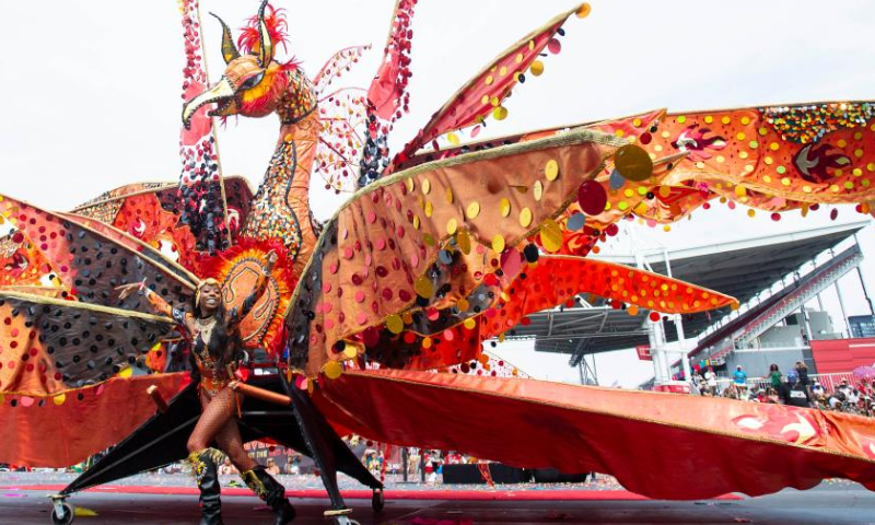 A dressed-up reveler performs with her float during the Grand Parade of the 2023 Toronto Caribbean Carnival in Toronto, Canada, on Aug. 5, 2023. (Photo by Zou Zheng/Xinhua)