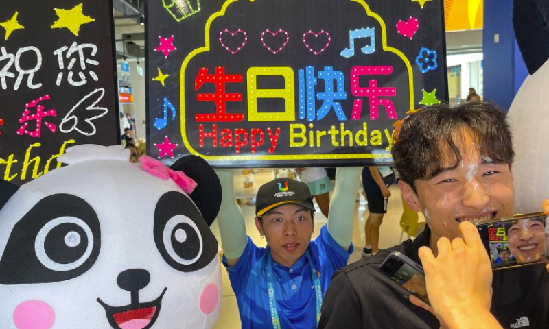 Water polo player Lee Sideok (1st R) of South Korea celebrates his birthday at the dining centre in the 31st FISU Summer World University Games Village in Chengdu, southwest China's Sichuan Province, July 30, 2023. (Xinhua/Shen Bohan)