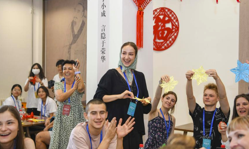 Sofia (C) learns paper-cutting at the Xinjiang Library in Urumqi, capital of northwest China's Xinjiang Uygur Autonomous Region, on July 23, 2023. This is an unforgettable tour of Xinjiang - wondrous! said Sofia Maksimovna Efremenko, a young Russian dancer who has spent a pleasant week here.

A member of the song and dance ensemble Zorenka of Balashov City, Saratov Oblast of Russia, Sofia came along with more than 1,000 of her counterparts from Asia, Europe and Africa for the 6th China Xinjiang International Dance Festival being held from July 20 to Aug. 5.

Besides their performance on stage, Sofia and her colleagues visited places of interest in Urumqi for a profound experience of the Chinese culture, particularly the traditions in Xinjiang. I'll definitely come again. (Xinhua/Hu Huhu)