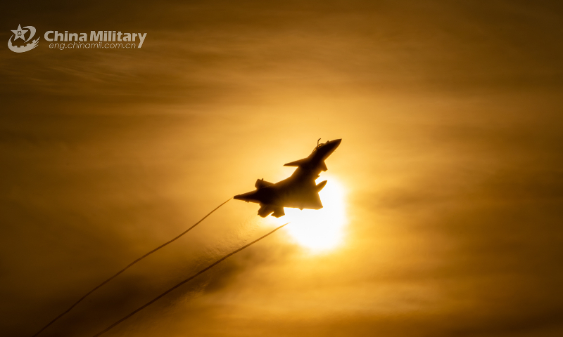 A J-10 fighter jet attached to an aviation brigade of the air force under the PLA Southern Theater Command takes off towards a training airspace at sunrise during a recent flight training exercise. (eng.chinamil.com.cn/Photo by Hou Kaiwen)  