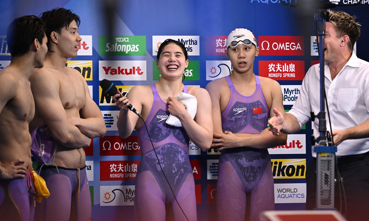 (From left) Chinese swimmers Xu Jiayu, Qin Haiyang, Zhang Yufei and Cheng Yujie have fun in an interview after their victory in the final of the mixed 4x100 meters medley relay during the World Aquatics Championships in Fukuoka, Japan on July 26, 2023. Team China put together a winning time of 3 minutes and 38.57 seconds. Photo: VCG
