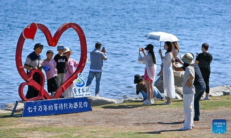 Tourists visit Sayram Lake in Bortala Mongolian Autonomous Prefecture, northwest China's Xinjiang Uygur Autonomous Region, July 25, 2023. (Xinhua/Ding Lei)