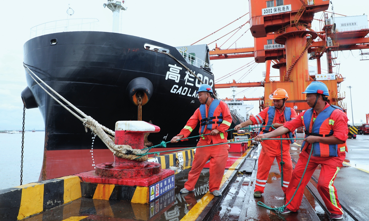 Workers reinforce the mooring of docked vessels with cables on July 27, 2023, in Zhangjiagang Port, East China's Jiangsu Province, in preparation for Typhoon Doksuri. Possibly the strongest typhoon to affect East China in a decade, Doksuri is expected to make landfall?in East China's Fujian Province on July 28, 2023. Photo: VCG