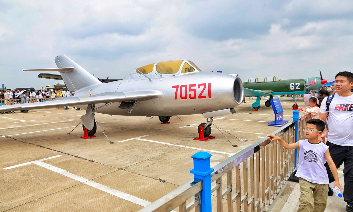 Visitors walk past a Mig-15bis once in service with the Chinese Air Force at the Chinese People's Liberation Ar-my (PLA) Air Force open-day event and the Changchun Aviation Exhibition on July 27, 2023 . The event is being held in Changchun, Northeast China's Jilin Province, from July 26 to 30, 2023. Photo: Li Hao/GT