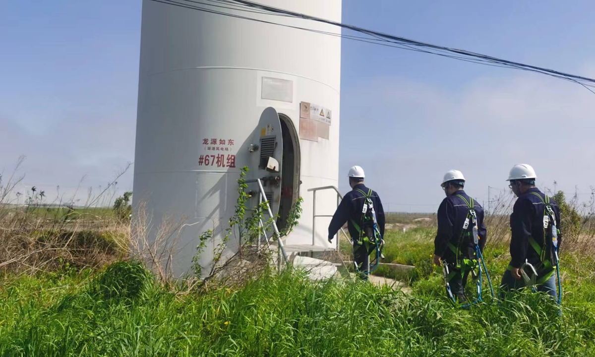 Engineer Ji Xiaoqiang and his colleagues step inside a windmill at the Longyuan Rudong Offshore Demonstration Wind Farm in May 2023. Photo: Hu Yuwei/GT